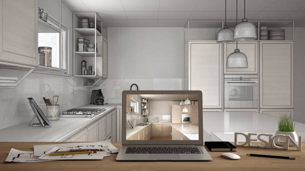 istock Architect designer desktop concept, laptop on wooden work desk with screen showing interior design project, blueprint draft background, modern white kitchen with wooden details 1136159608