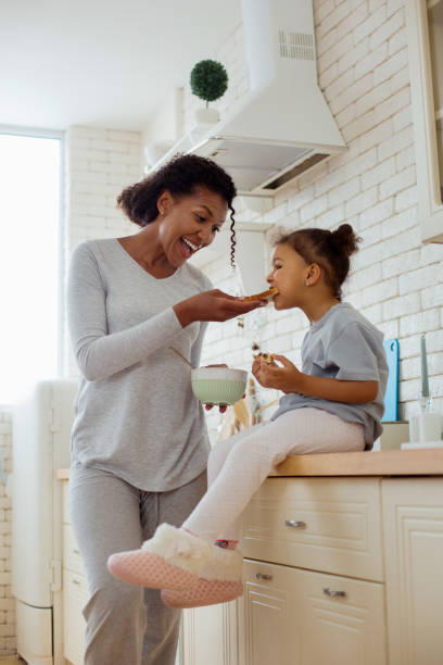 istock Amazing curly-haired woman keeping smile on her face 1136159626