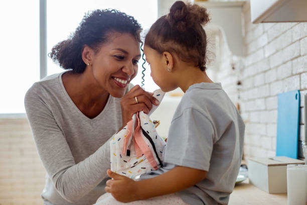 istock Cheerful brunette female person looking at her kid 1136159631