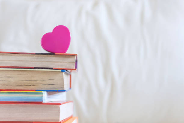 istock Stack of books and pink heart on the white bed. Education background with Copy space, back to school concept. 1136159701