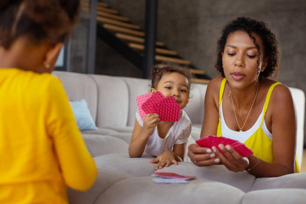 istock Charming international kid demonstrating her cards on camera 1136161596