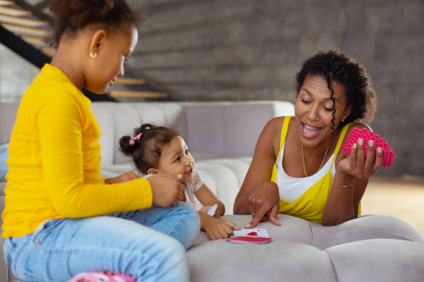 istock Happy young brunette woman pointing at card 1136161606