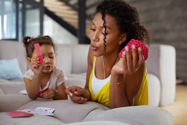 istock Pleased curly-haired female person leaning on sofa 1136161609