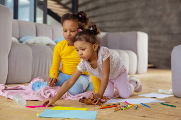 istock Concentrated kids going to draw picture together 1136161668