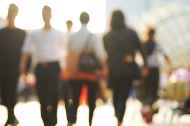 background of blurred people walking on street in afternoon stock photo