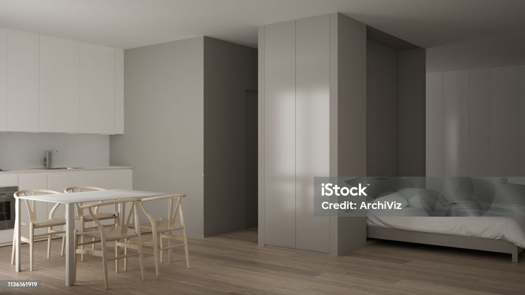 Small apartment with parquet floor, kitchen in white living room, office in minimalist style, Murphy bed, roll-away, modern architecture concept Alcove Stock Photo