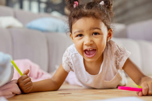 istock Positive delighted child demonstrating her friendly smile 1136161985
