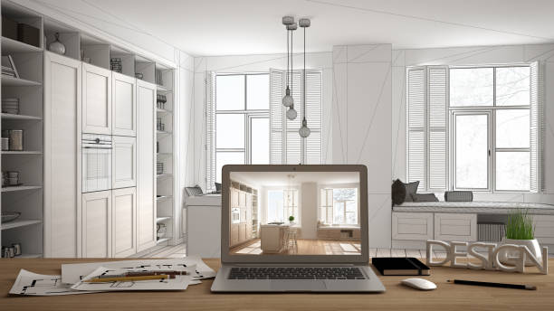 istock Architect designer desktop concept, laptop on wooden work desk with screen showing interior design project, blueprint draft background, modern white kitchen with wooden details 1136163107