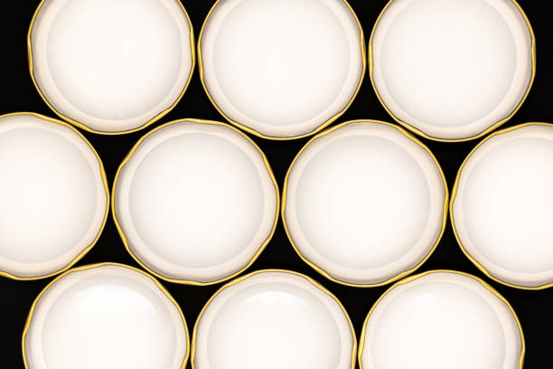 Inner side of golden jar lids on black background