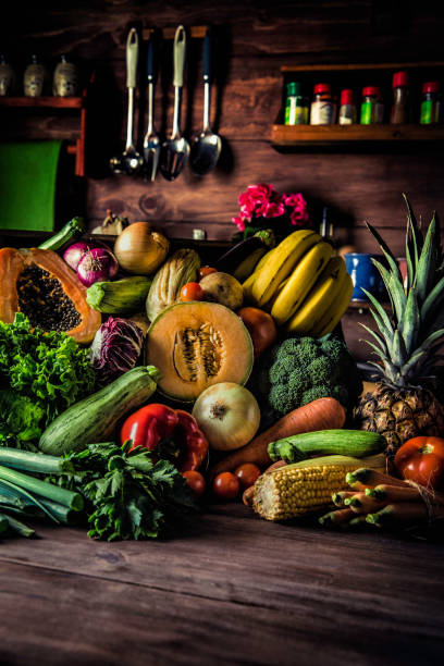 istock Organic tropical fruits and vegetables in old fashioned rustic kitchen 1136164654