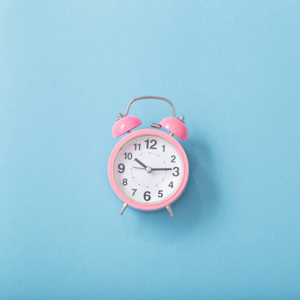 istock alarm clock on pastel paper background 1136165604