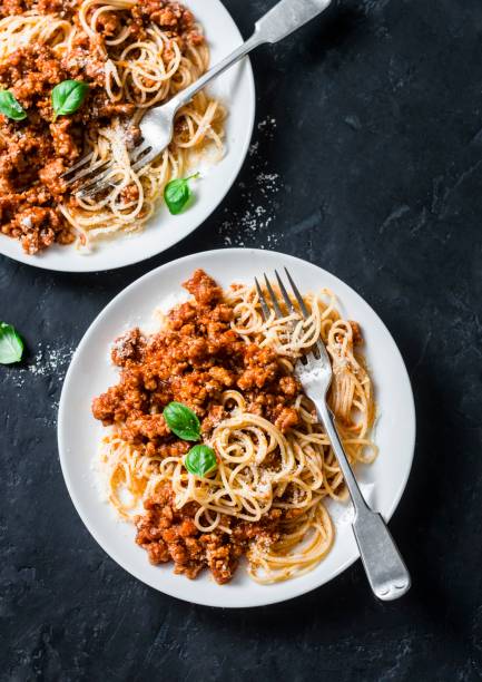istock Mashed beans, mushrooms vegetarian bolognese sauce with spaghetti on a dark background, top view 1136165964