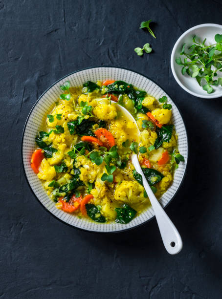 istock Vegetarian vegetables and yellow lentils stew on dark background, top view 1136166098