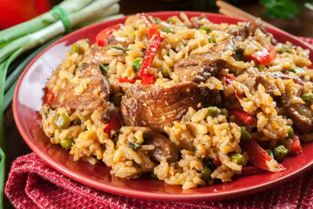 Photo of Fried rice with chicken and vegetables served on a plate