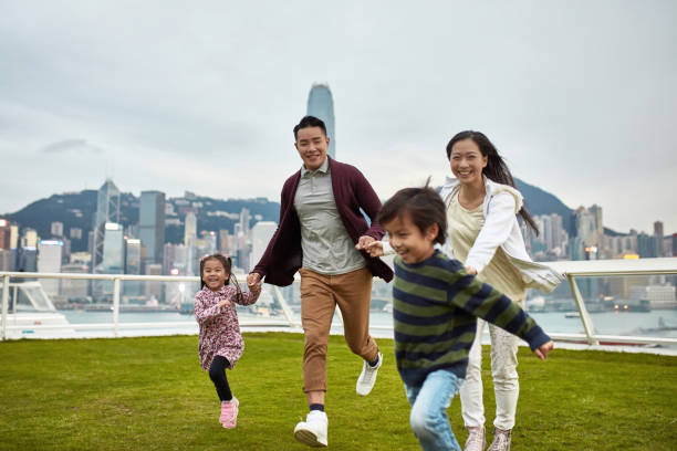 istock Cheerful family holding hands running at park 1136167461