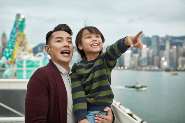 istock Happy boy pointing to father at public park 1136168076