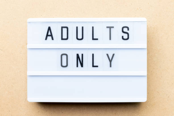 istock White lightbox with word adults only on wood background 1136170734