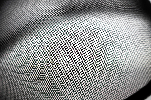 Detail of a metallic strainer forming and interesting geometric texture. It can be used as background