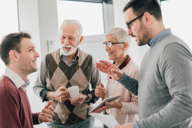 istock Coworkers talking and holding digital tablet 1136172183