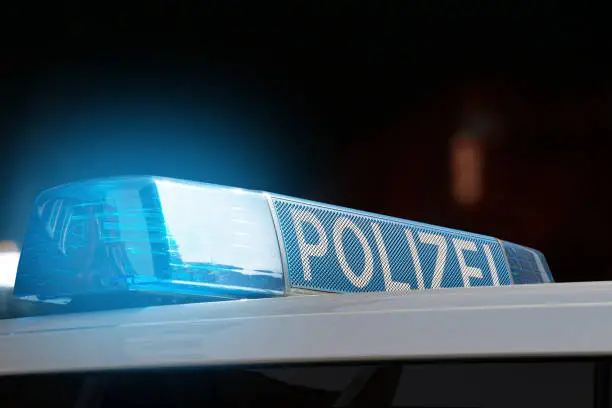 german police car with flashing lights at night