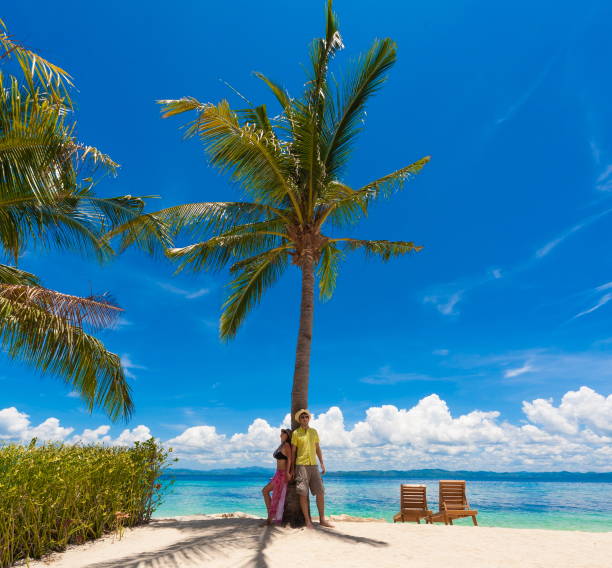 istock Philippines,  woman and man beach palm 1136176177