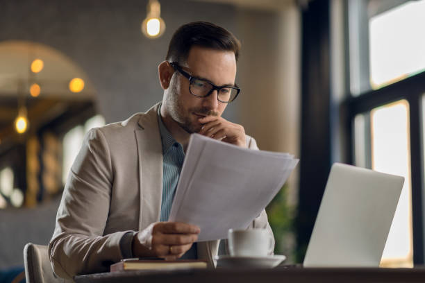 istock Young  businessman working on business reports in the office 1136176190