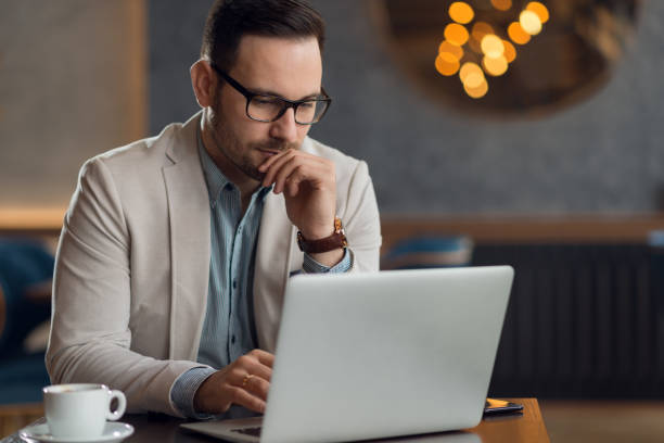 istock Young  businessman working on computer in a cafe. 1136176217