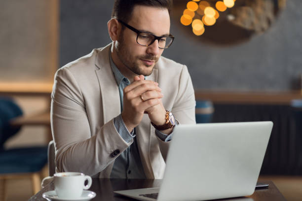 istock Young  businessman working on computer in a cafe. 1136176244