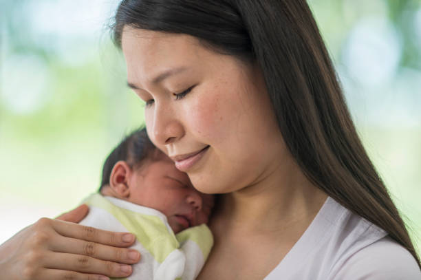 istock Mother Carrying Her Baby 1136176267