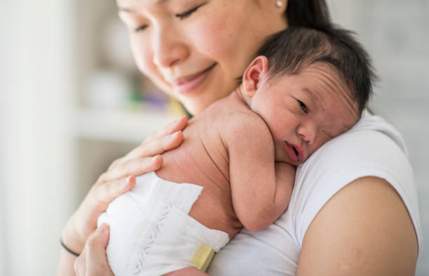istock Mother Carrying Her Baby 1136176278