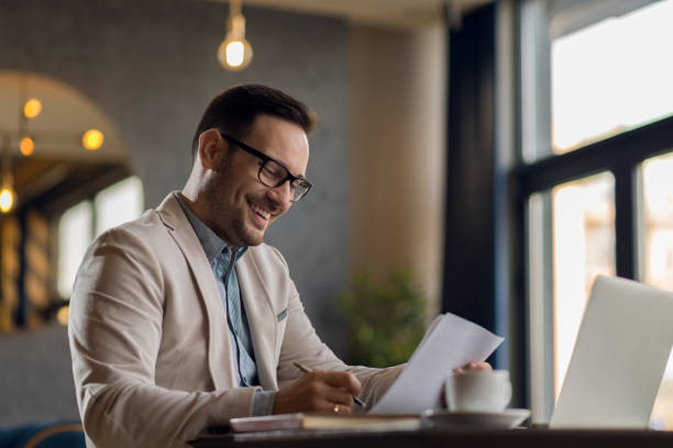 istock Young businessman going through reports in the office 1136176309