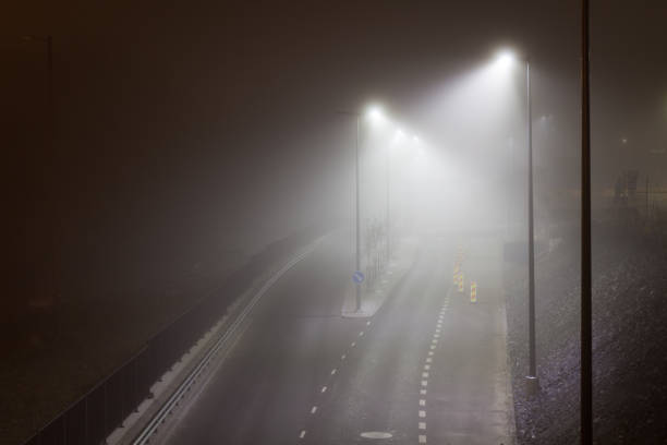 istock Empty street at foggy night 1136176327