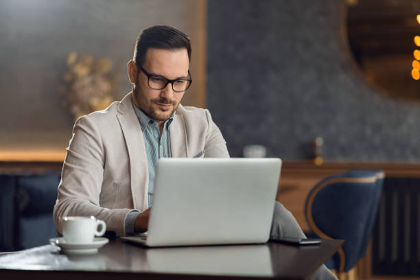 istock Young businessman using laptop in a cafe 1136176534
