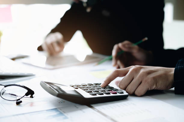 istock Business and partners discussing new plans marketing financial graph data on office table with using calculator in meeting 1136176811