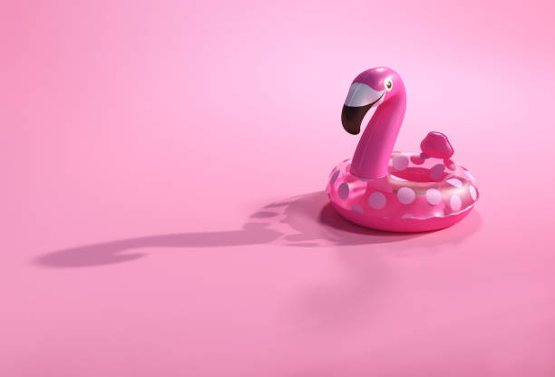 istock Summer backgrounds. 3d flamingo shape inflatable swimming pool ring for floating. Vacation and traveling accessories for beach and sea. 1136177381