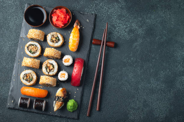 istock Set of sushi and maki on stone table. 1136178010