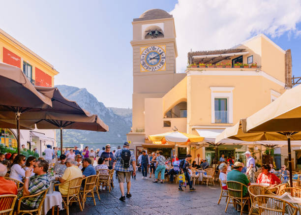People at Square with Church in old town of Capri Capri, Italy - October 3, 2017:  People at Piazza Umberto I Square with Church of Santo Stefano in old town of Capri Island town at Naples, Italy. Landscape at Italian coast. Anacapri in summer Amalfi sorrento italy photos stock pictures, royalty-free photos & images