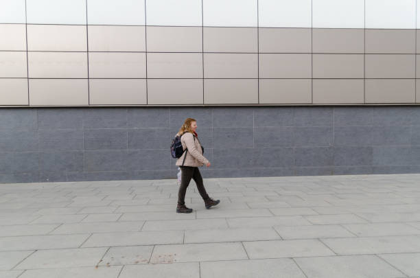 istock Woman is walking on the sidewalk. 1136180280