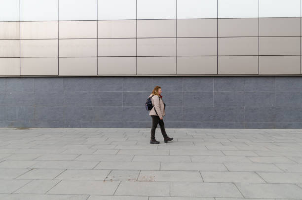 istock Woman is walking on the sidewalk. 1136180326
