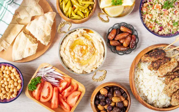 Photo of Iftar food table. Evening meal for Ramadan. Arabic cuisine. Middle Eastern traditional lunch. Assorted of Egyptian oriental dishes. Top view
