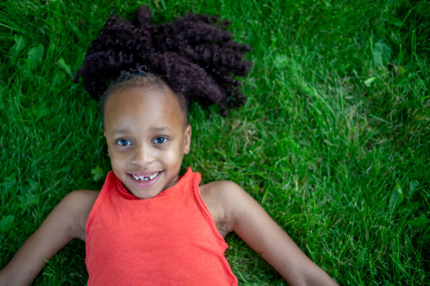 istock Happy Girl Laying In Grass 1136181096