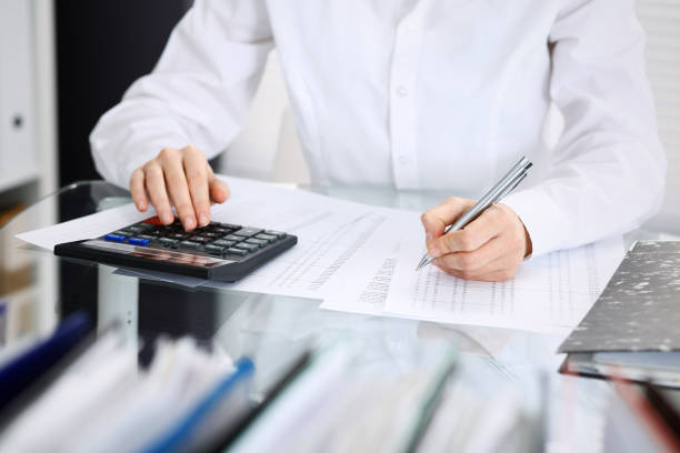 istock Unknown bookkeeper woman or financial inspector  making report, calculating or checking balance, close-up. Business portrait. Audit or tax concepts. 1136181244
