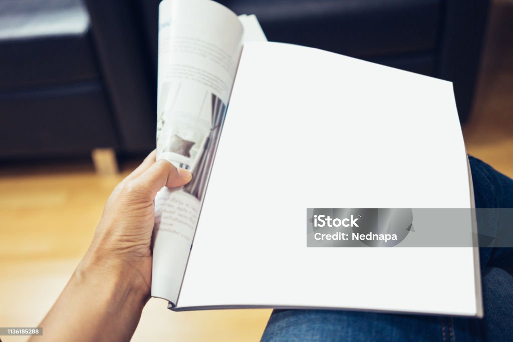 woman reading a magazine woman sitting at the table with reading a magazine in coffee shop. Magazine - Publication Stock Photo