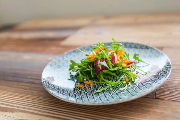 istock Side Dish of Rucola Salad on Wooden Table 1136186747