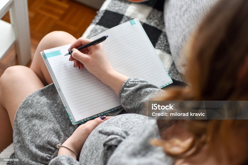Pregnant woman writing names for her baby Letter - Document, Pen, Serbia,  Pregnant, Women Pregnant Stock Photo