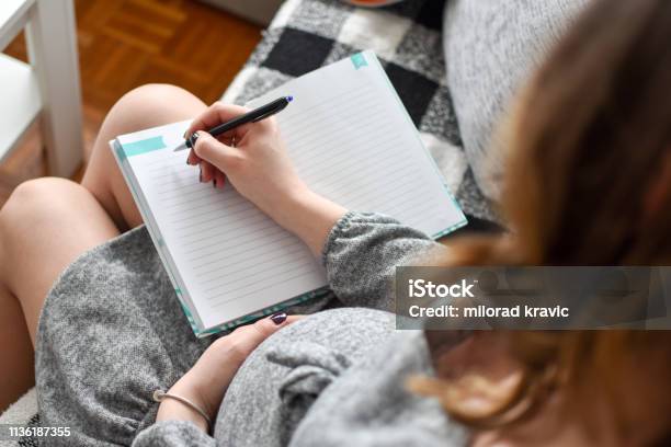 Pregnant Woman Writing Names For Her Baby Stock Photo - Download Image Now - Pregnant, Writing - Activity, Women