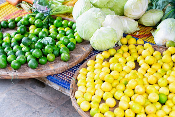 asian fruit assortment such as limons and lime hoi an - lime market vietnam fruit imagens e fotografias de stock