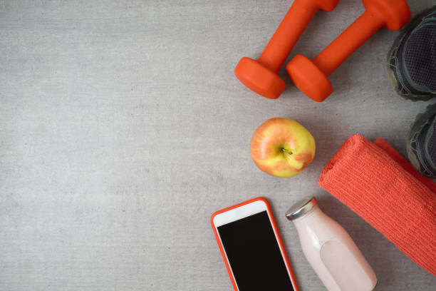 istock Fitness background with dumbbells, protein shake, apple and towel. 1136190440