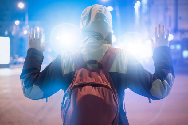 male suspect arrested in the night city, with police flashers behind him male suspect arrested in the night city, with police flashers behind him child crimes stock pictures, royalty-free photos & images