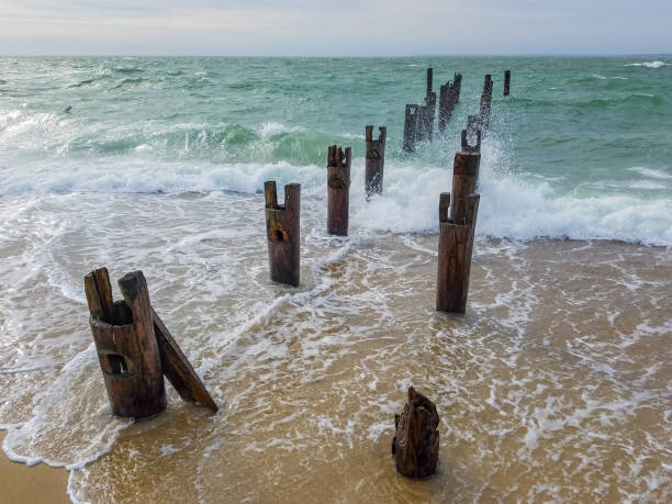 istock Waves Crash on the Ruined Piers 1136192568